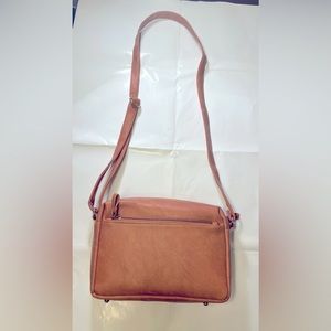 Brand new light brown vegan leather women’s hand bag.